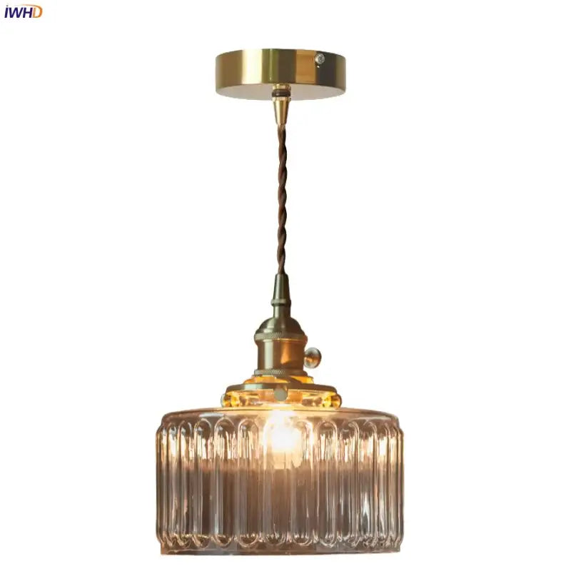 Vintage pendant light with a brass fixture, twisted cord, and clear glass led ribbed cylindrical shade decorbites clear glass