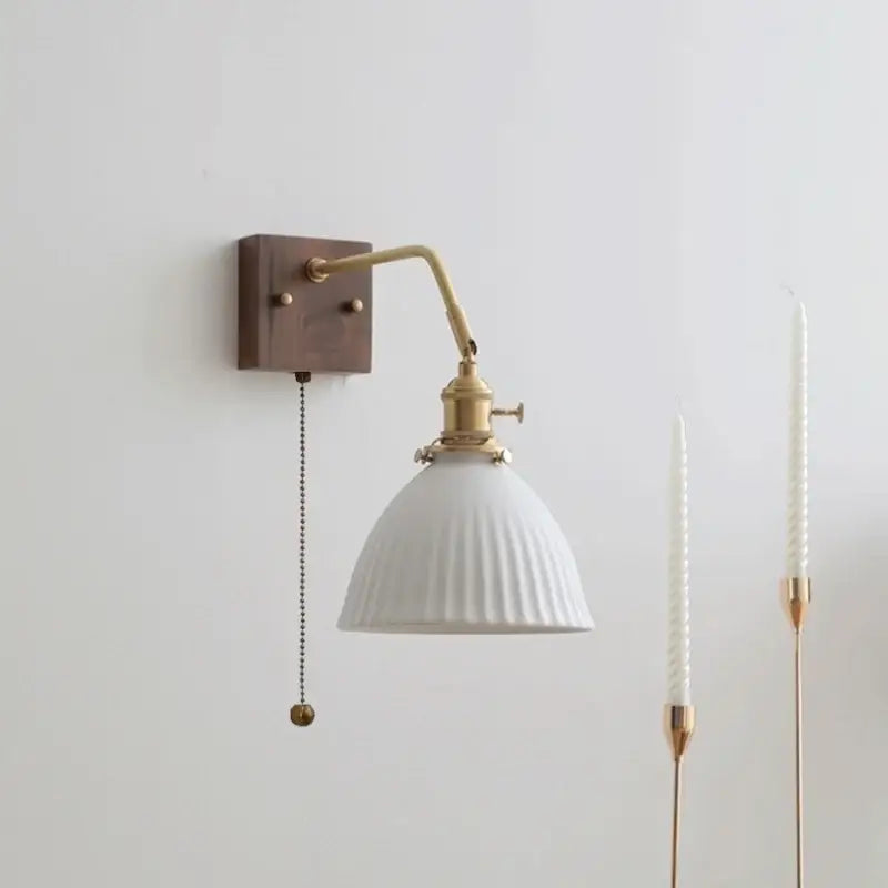 Vintage ribbed ceramic copper led wall lamp with white ribbed ceramic shade, brass arm, dark wood plate, and pull chain switch