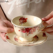 Cream-colored porcelain coffee mug and saucer set with red rose floral patterns and gold trim vintage dining room set