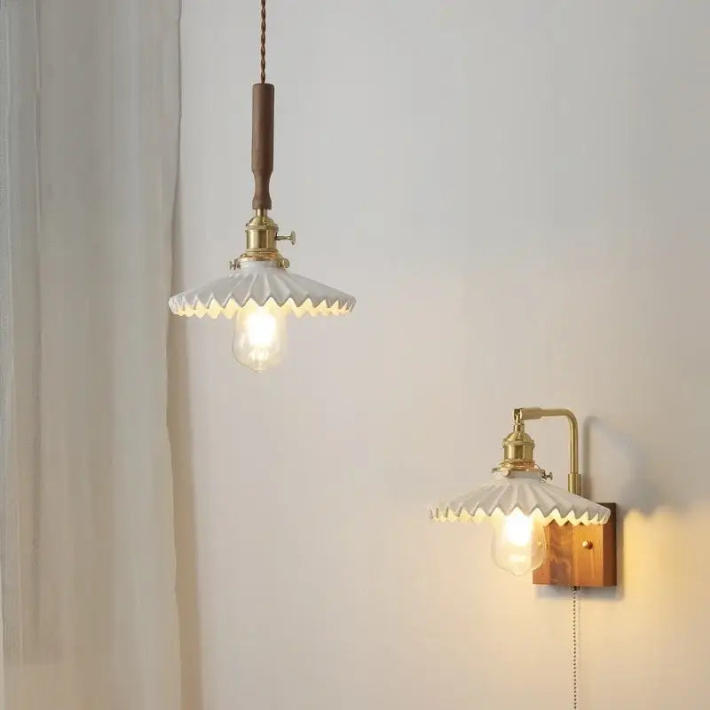 White ceramic pendant light fixture with brass accents and walnut wood designed for dining room use