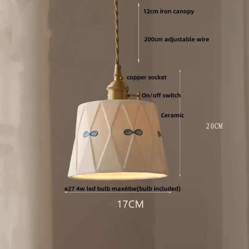 White ceramic pendant light fixture with geometric facets and blue bow designs and walnut wood for dining room