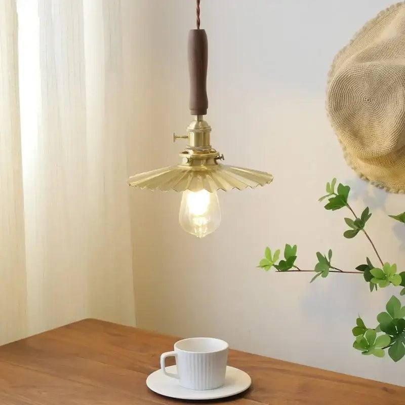 A brass scalloped pendant light with wooden handle and fluted shade featuring exposed bulb for dining room decorbites copper walnut led
