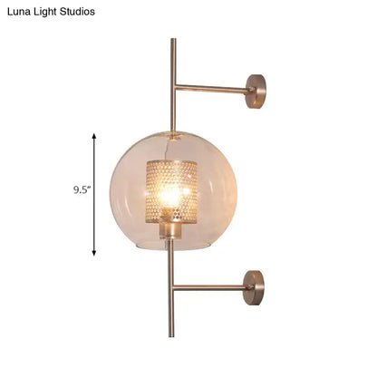A vintage silver and gold clear glass sconce light with brushed brass finish and honeycomb glass globe for bedroom walls