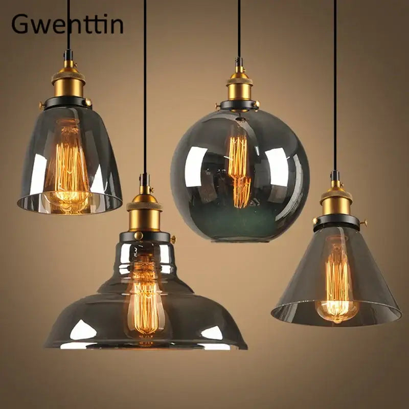 Set of four vintage smoked glass and brass industrial glass pendant lights with exposed filament bulbs for kitchen decor