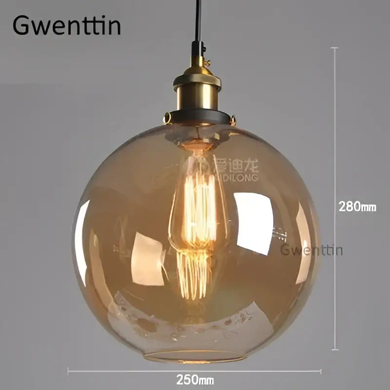 Amber-tinted glass globe pendant light with brass finish and exposed filament bulb for kitchen decorbites industrial glass decor