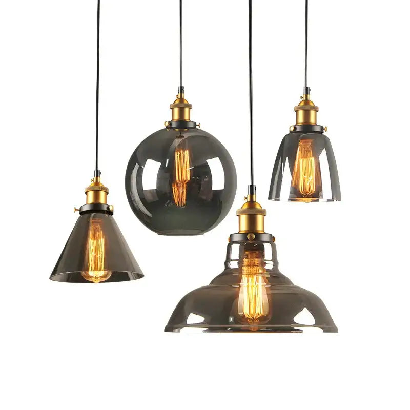 Set of five dark smoked glass ball pendant lights with brass accents and exposed filament bulbs by decorbites