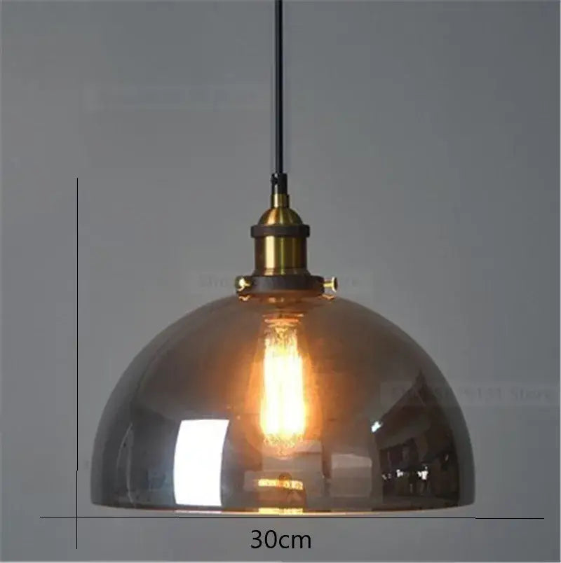Warm-toned vintage smoked glass ball pendant lights set of 4 with brass accents and amber decorbites glass ball fixture