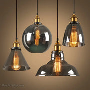 Set of four vintage smoky grey glass pendant lights with brass accents and exposed filament bulbs for kitchen decorbites smoky grey