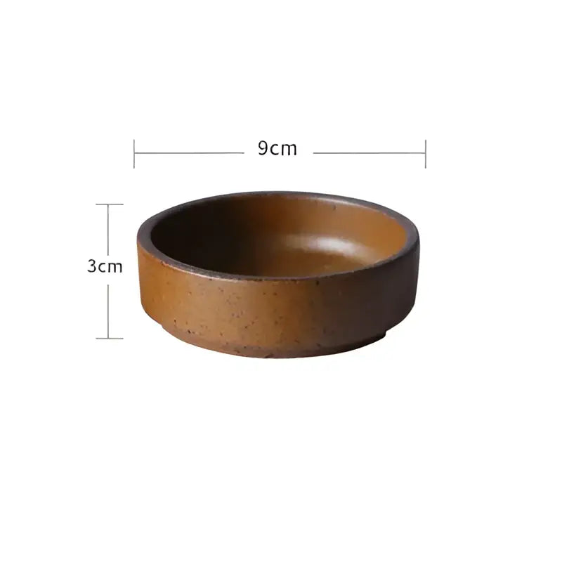 A rustic vintage speckled brown ceramic round swallow plate with matte finish and uneven edges for decorbites ceramic round collection
