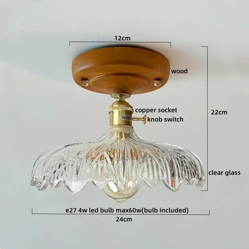 A clear glass copper led ceiling lamp with wooden base brass socket and fluted design for dining room lighting