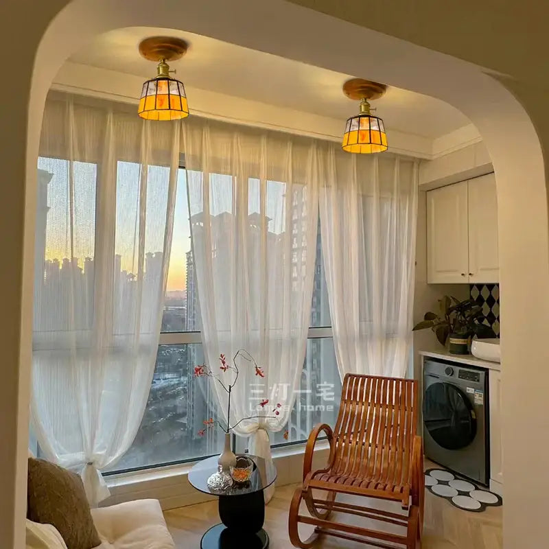 Two warm-toned vintage stained glass copper led ceiling lamps with brass fixtures and amber shades for dining room use