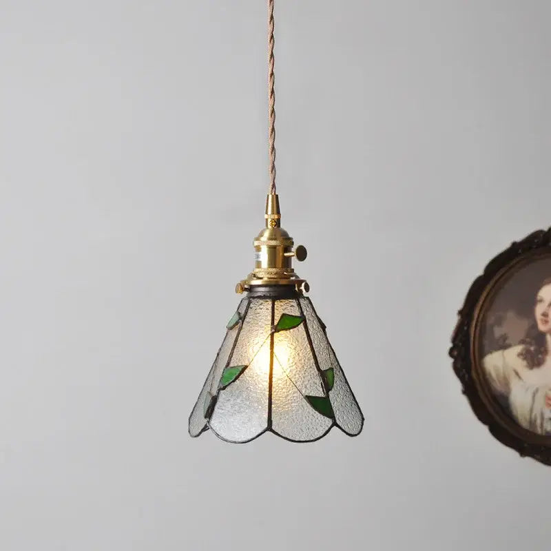 Vintage stained glass copper pendant light with brass fixture, green leaf glass shade, and wood knob switch for kitchen