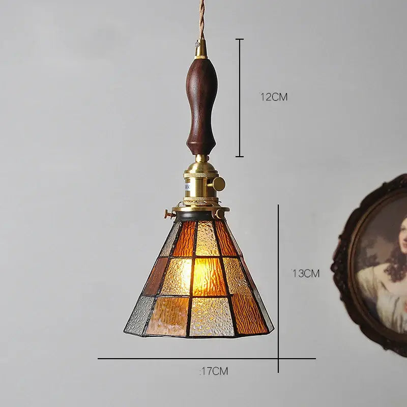 Vintage stained glass copper pendant light with amber textured panels, dark wood knob switch, and brass hardware for kitchen