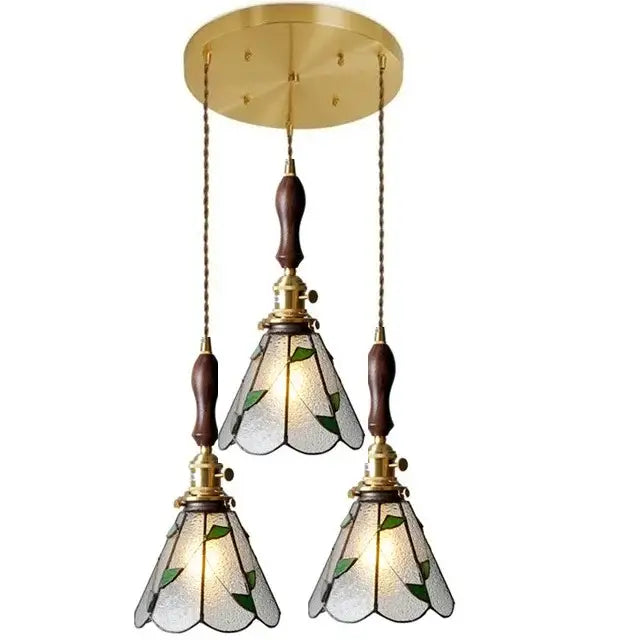 Brass-finished glass copper pendant light with three green leaf stained glass shades and wood knob switch for kitchen