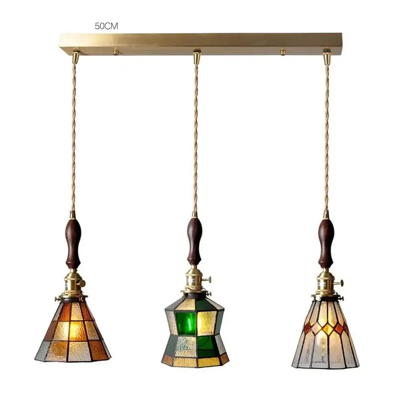 Three-piece vintage stained glass copper pendant light with brass hardware dark wood knob switch for kitchen use