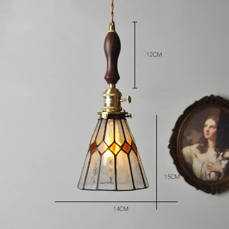 Vintage stained glass copper pendant light with amber and clear panels, dark wood knob switch, and brass hardware