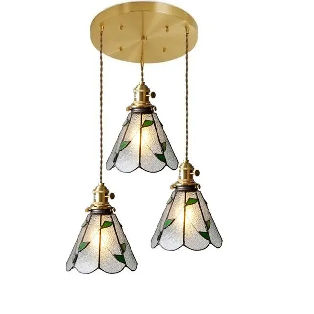Three vintage stained glass copper pendant lights with brass fixtures and wood knob switch for kitchen use