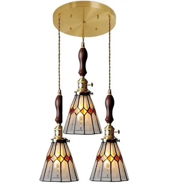 Brass-finished glass copper pendant light with stained glass shades and wood knob switch for kitchen use