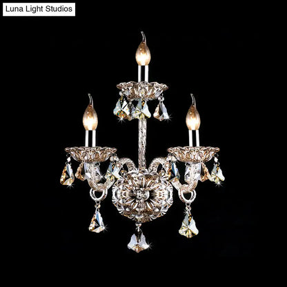 Elegant vintage style wall light featuring three-arm silver-toned metalwork with amber crystal candle accents