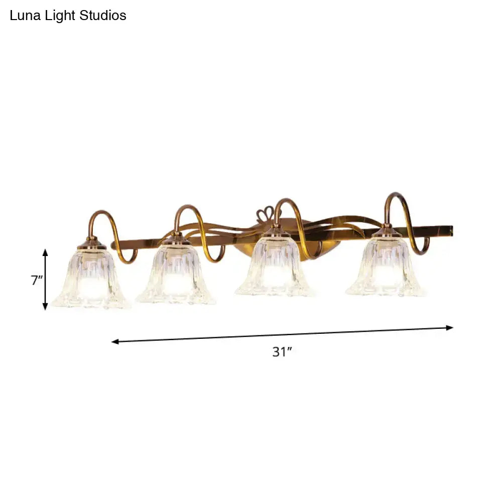 Vintage style antique brass wall light with four clear bell-shaped glass shades for bathroom vanity lighting