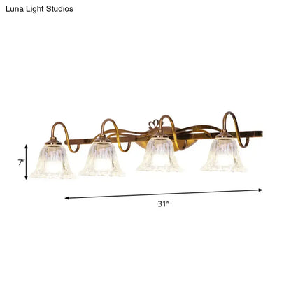 Vintage style antique brass wall light with four clear bell-shaped glass shades for bathroom vanity lighting
