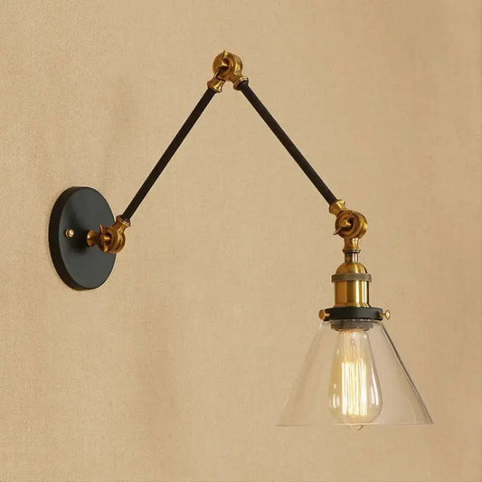 Vintage style decorbites wall sconce with satin brass hardware black articulated arms and clear glass shade with filament bulb
