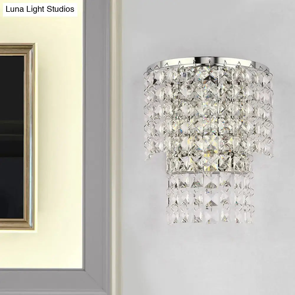Vintage style wall sconce with sleek chrome frame and cascading clear crystal tiers for elegant bedroom lighting