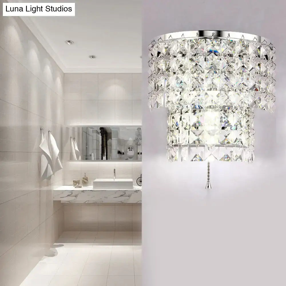 Vintage style wall sconce with sleek chrome frame and cascading clear crystal tiers for elegant bedroom lighting