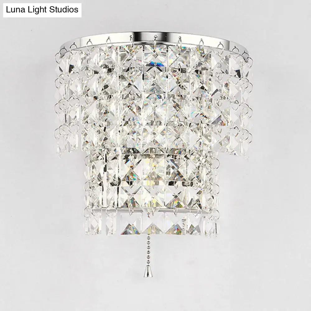 Vintage style gold and chrome wall sconce with a crystal chandelier featuring faceted clear crystals and cascading tiers