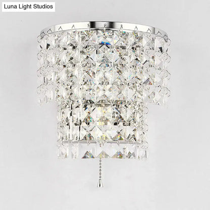 Vintage style gold and chrome wall sconce with a crystal chandelier featuring faceted clear crystals and cascading tiers