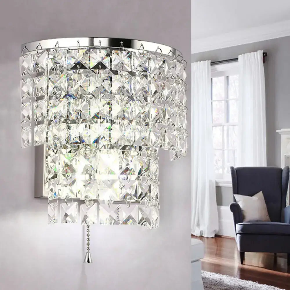 A vintage style wall sconce with polished chrome frame and cascading clear crystal tiers for bedroom lighting