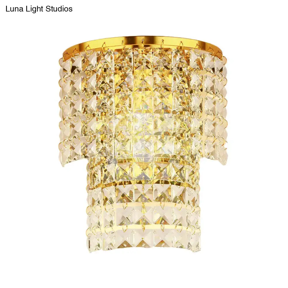 Vintage style wall sconce featuring a gold-toned crystal chandelier with faceted glass and polished brass frame