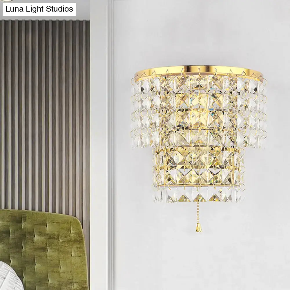 Vintage style gold and chrome wall sconce with cascading clear faceted crystal tiers for bedroom lighting
