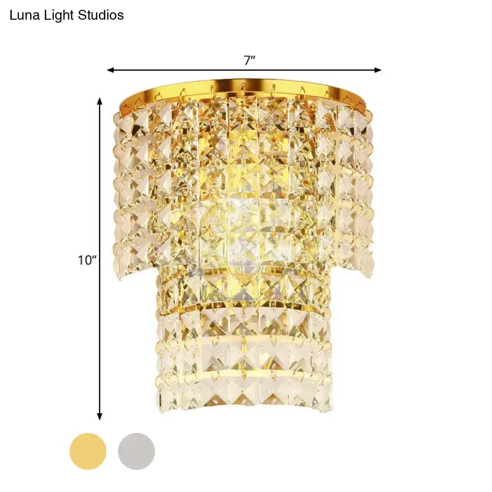 Vintage style gold and chrome wall sconce with a gold-toned crystal chandelier and tiered cascading design