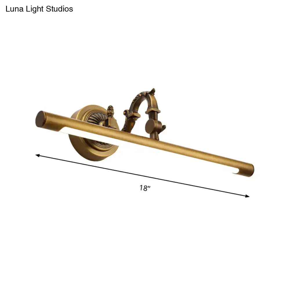 Antique brass-finished vintage style wall light with gold metallic tubular design and ornate details for bathroom vanity use
