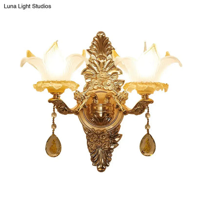 Vintage style gold wall light with opal glass lily shades and amber crystal accents for bedroom decor