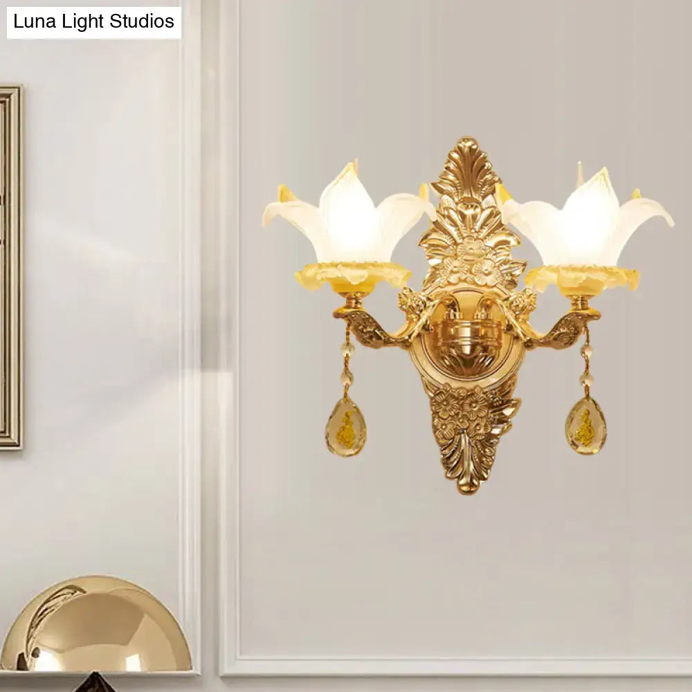 Gold vintage style wall light with opal glass petal shades and crystal teardrop pendants for bedroom use