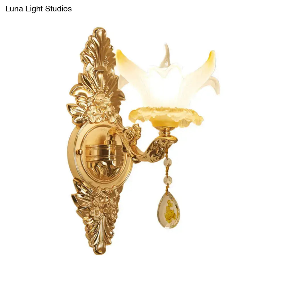 Vintage style gold wall light with opal glass frosted yellow flower shade and dangling crystal pendant for bedroom use
