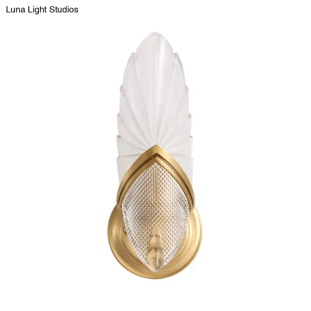 Vintage style wall lamp with frosted glass feather-like shade and gold-toned metal frame for bedroom use