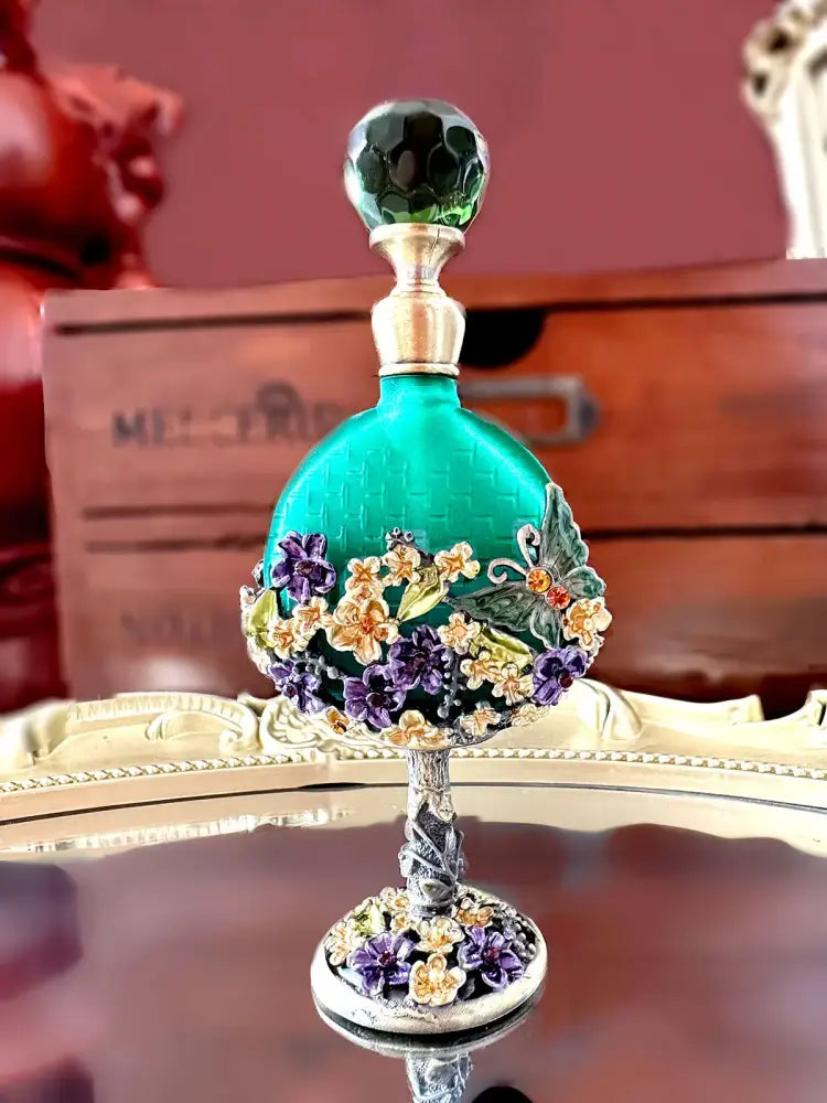 Vintage teal and purple glass perfume bottle with green stopper and ornate silver base for bedroom decor