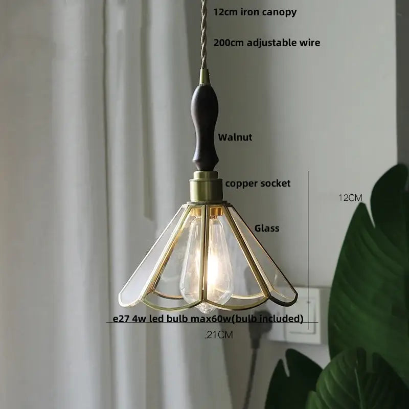 Vintage teal blue glass led pendant light with dark walnut handle brass accents and gold-toned metal decorbites blue glass