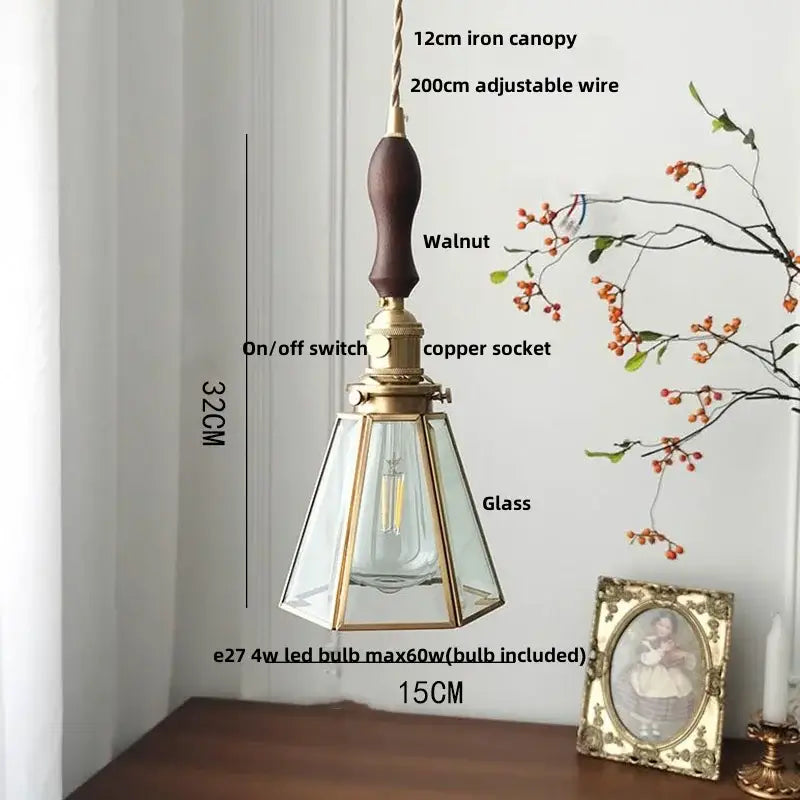 Vintage teal blue glass led pendant light with dark walnut handle brass accents and gold-toned metal decorbites blue glass
