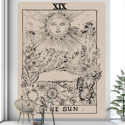 Beige wall hanging featuring a black ink sun tarot card illustration with floral and mountain designs tarot witchcraft tapestry decorbites black