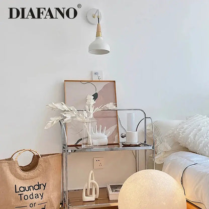 White vintage wall lamp with ceramic body wooden accent and conical shade for bedroom lighting mounted on wall