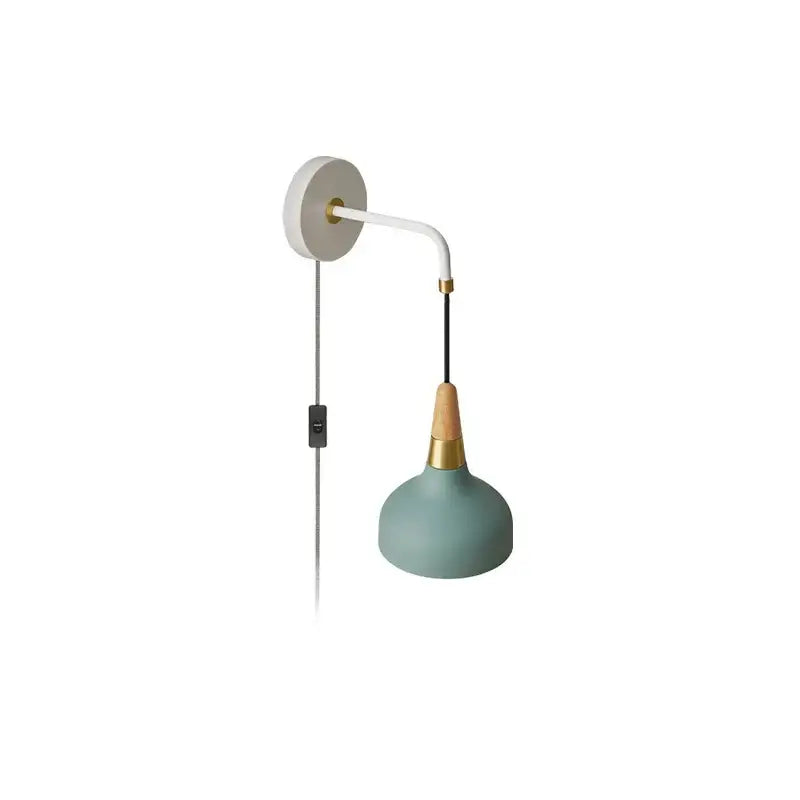 Vintage wall lamp with a matte sage green shade brass accents white curved arm and wood detail for bedroom lighting