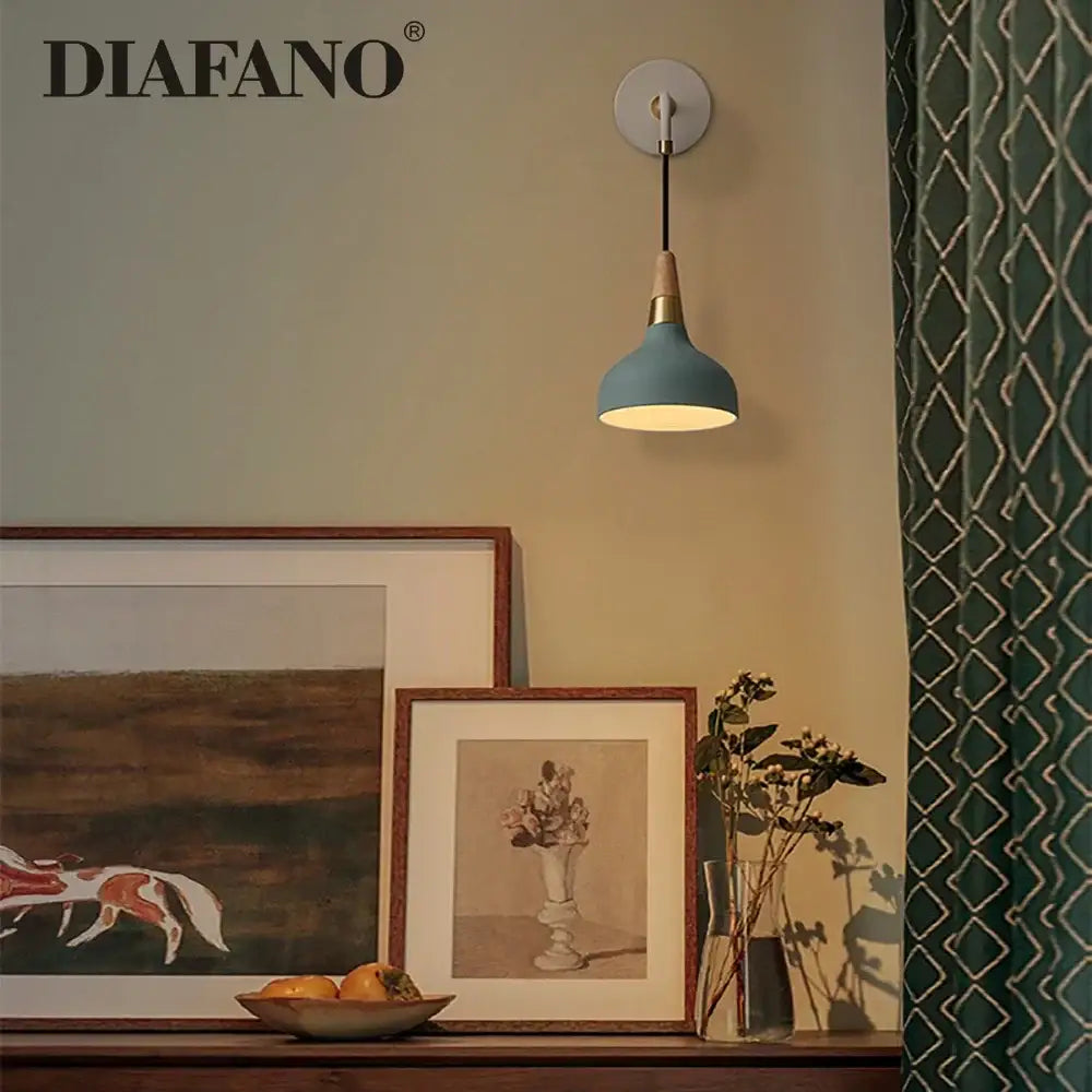 A vintage wall lamp featuring a sleek light blue matte finish with wooden accents for bedroom lighting