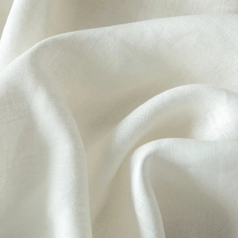 Vintage white and gray linen bedding set featuring soft off-white linen fabric with subtle textured weave and gentle folds