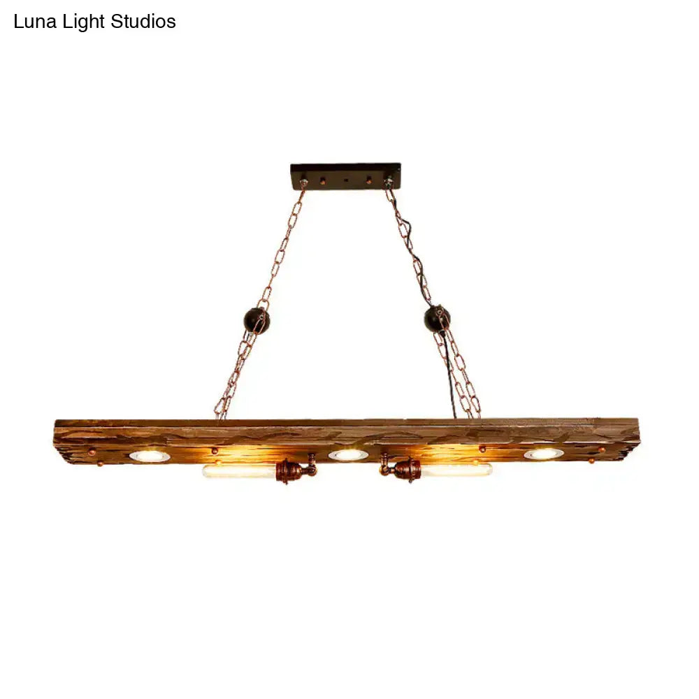 Rustic wooden ceiling pendant light with three exposed Edison bulbs and dark metal chains for dining room use