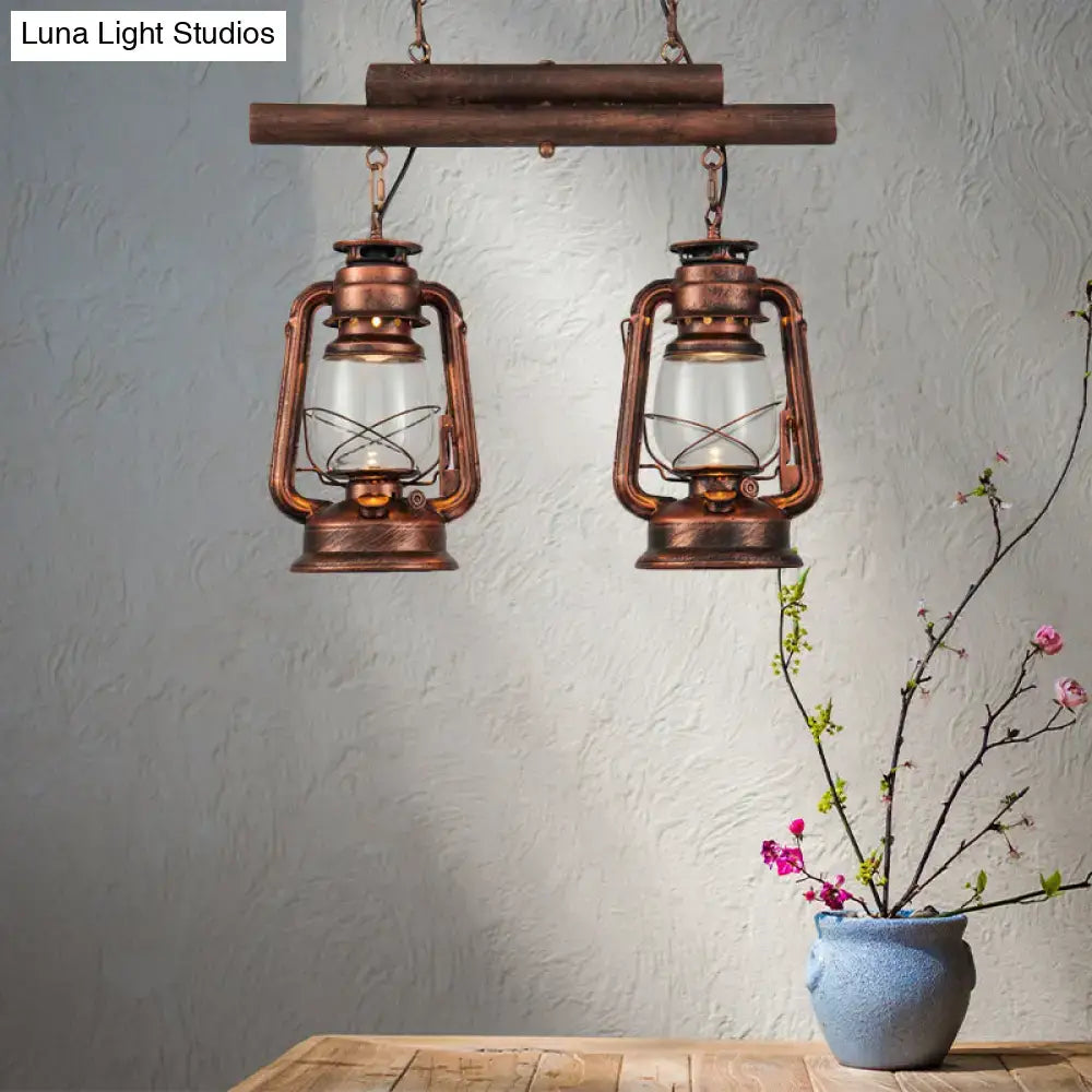 Vintage-style DecorBites copper lantern island light with clear glass and intricate metalwork hanging from wooden bar