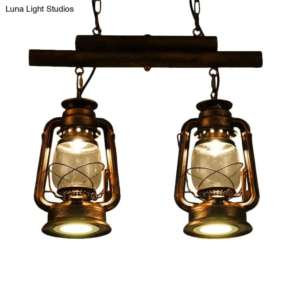 Vintage-style brass decorbites™ copper lantern island light with clear glass bulbs hanging from dark wooden beam